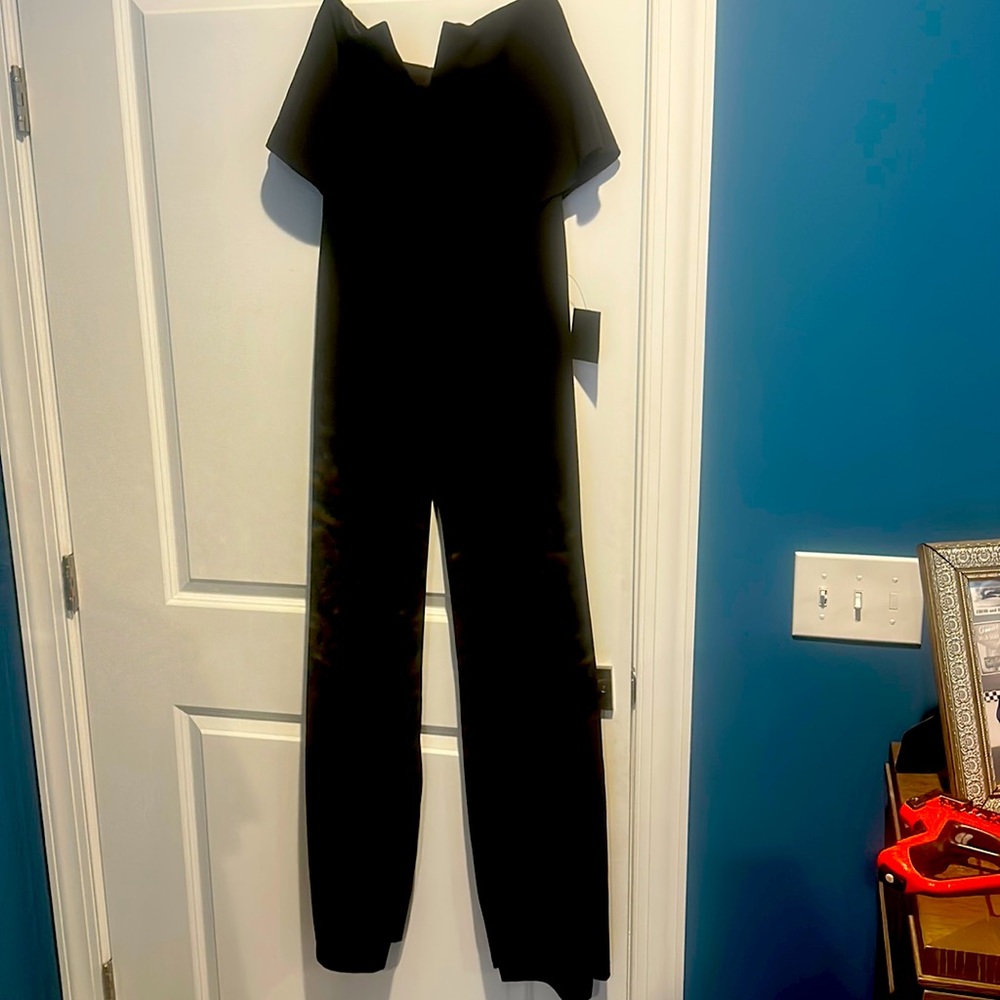 Brand new jumpsuit with tags. Strapless. Black. Great detail at chest